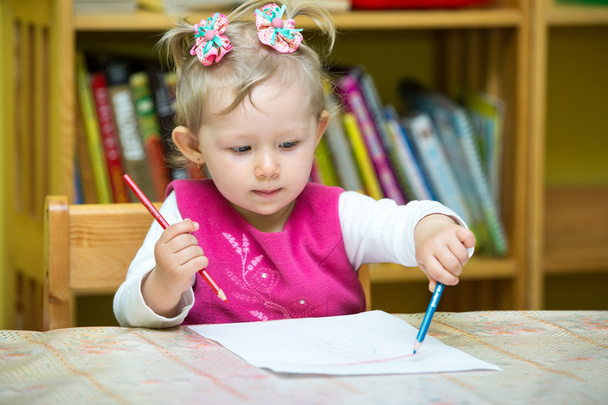 Child girl drawing with pencils in preschool - 写真・画像