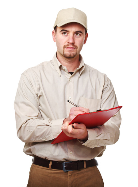 Young caucasian delivery man at work isolated on white background - 写真・画像