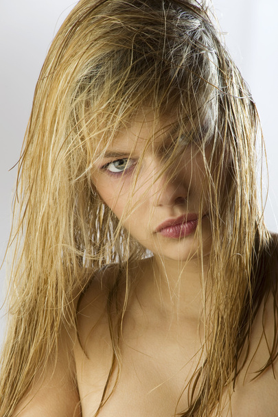 attractive and beautiful blond girl with long wet hair on her face - Fotografie, Obrázek
