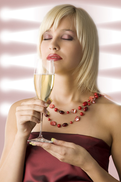 cute blond with cup of champagne in act to smell it - Фото, зображення