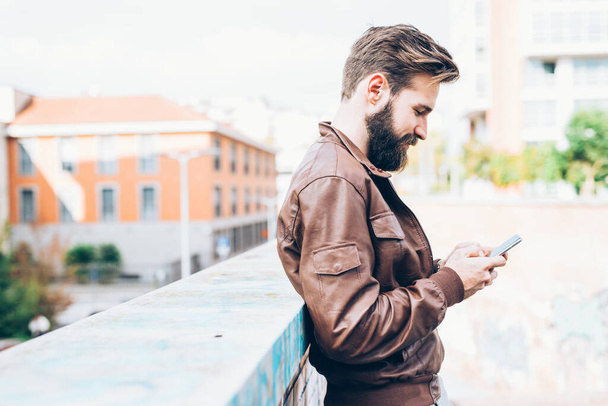 young handsome bearded man using smartphone shopping online - Foto, Bild