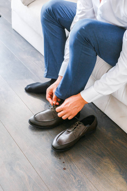 the man is wearing black leather shoes - Photo, image