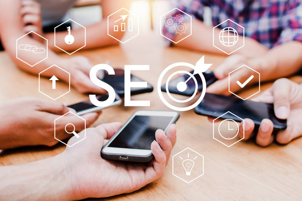 SEO Search Engine Optimization concept with phone community team. Group of teamwork working to high ranking traffic on website, internet technology for business digital company. - Photo, Image