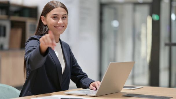 Serious Businesswoman with Laptop Pointing at the Camera  - Foto, imagen