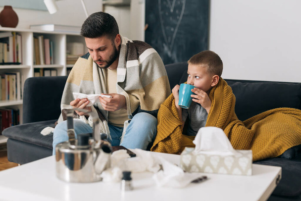 father and son have flue. they are at home - Фото, изображение