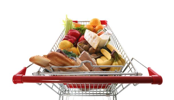 Shopping cart full of groceries on white background, above view - Фото, зображення
