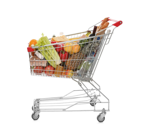 Shopping cart full of groceries on white background - Photo, Image