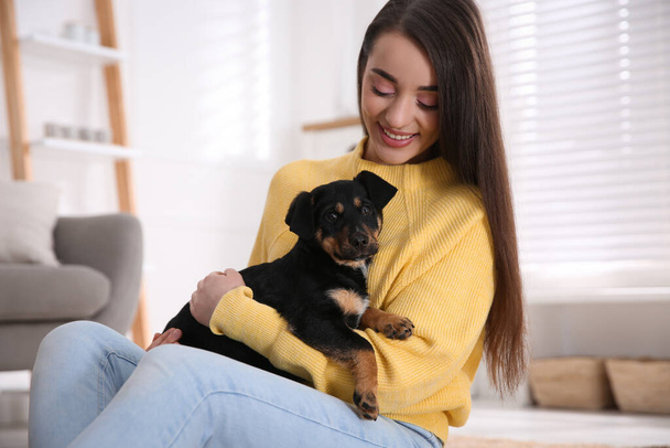 Woman with cute puppy indoors. Lovely pet - Fotoğraf, Görsel