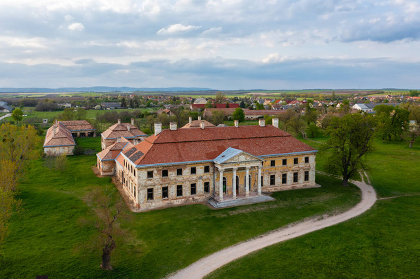 Lovasbereny, Hungary - Aerial view about abandoned Cziraky Castle with cloudy sky at the background. - Photo, Image