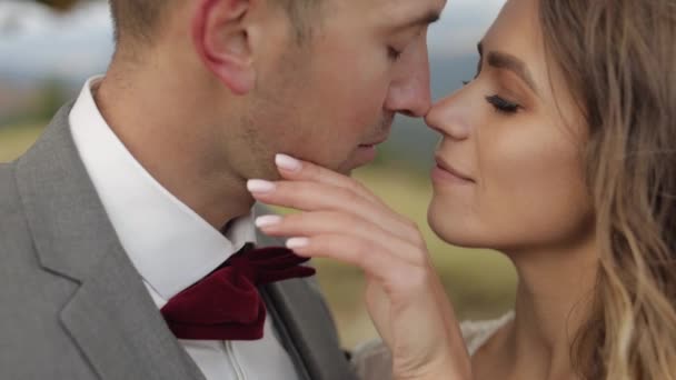 Schöne junge Braut und Bräutigam umarmen, umarmen sich am Berghang, Hochzeitspaar verliebt - Filmmaterial, Video