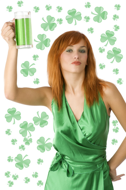 cute redhead girl posing in green dress with a glass of green beer - Fotó, kép