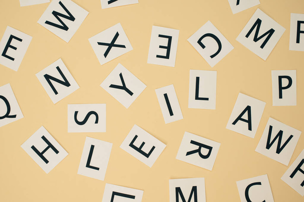 A top view of scattered English letters on brown background - 写真・画像
