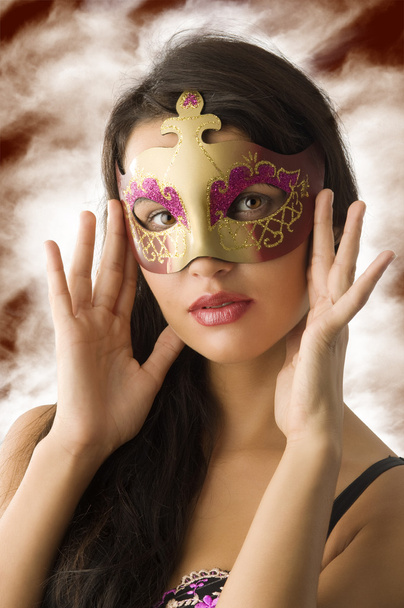 close up of cute brunette with carnival golden mask - 写真・画像