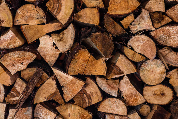 A closeup shot of cut and stacked dry wood for wallpaper and background - Photo, Image