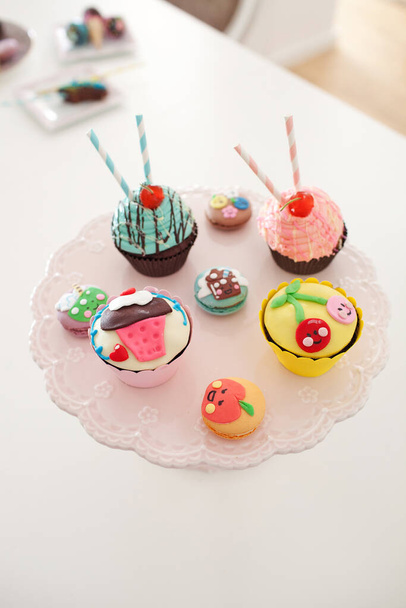 Close up image of assorted colorful cupcakes and macaroons - Valokuva, kuva