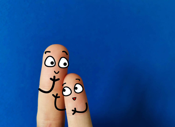 Two fingers are decorated as a parent and a child.They are spending time together happily. - Photo, Image