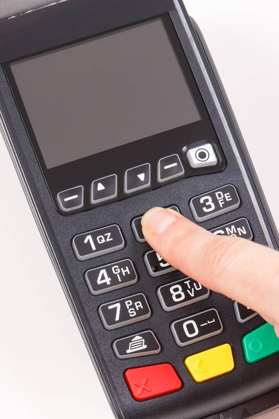 Hand of woman entering PIN code on payment terminal. Cashless paying for shopping. Credit card reader. Finance concept - Foto, Imagen