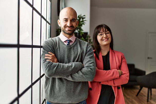Two hispanic business workers smiling happy with arms crossed gesture standing at the office. - Fotografie, Obrázek