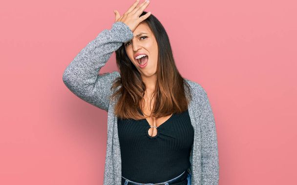 Beautiful hispanic woman wearing casual clothes surprised with hand on head for mistake, remember error. forgot, bad memory concept.  - Fotoğraf, Görsel