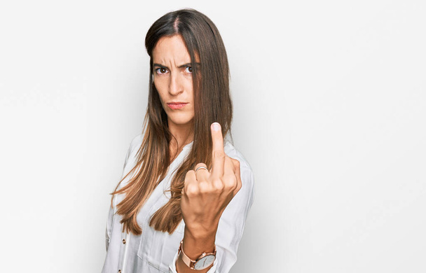 Young beautiful woman wearing casual clothes showing middle finger, impolite and rude fuck off expression  - Foto, Imagen