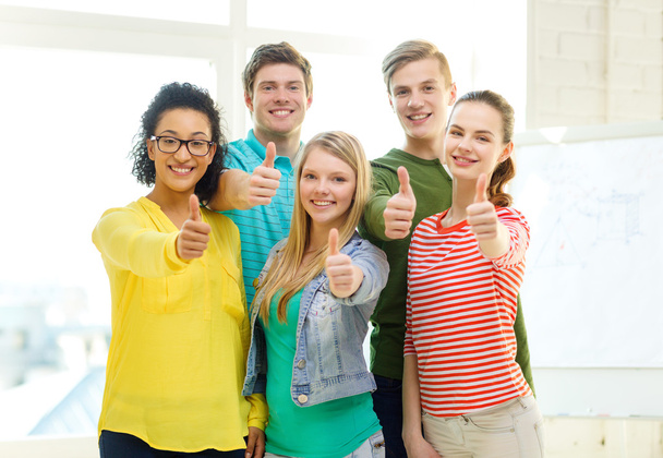five smiling showing thumbs up at school - Foto, Imagen