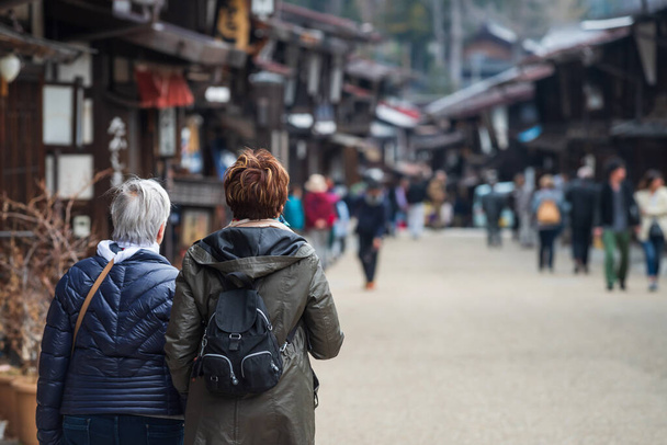 Eski yabancı kadın turist Narai-juku ziyareti tarihi posta kasabasını ve Kiso vadisi, Shiojiri, Nagano, Japonya 'daki eski ahşap evleri korudu. Chubu 'daki ünlü seyahat yeri veya simgesi.. - Fotoğraf, Görsel