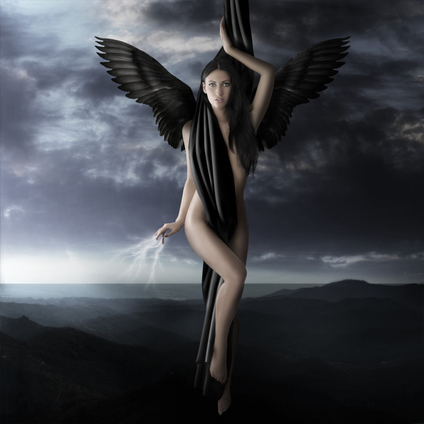 naked black angel flying to heaven in a lightning night sky - Фото, изображение