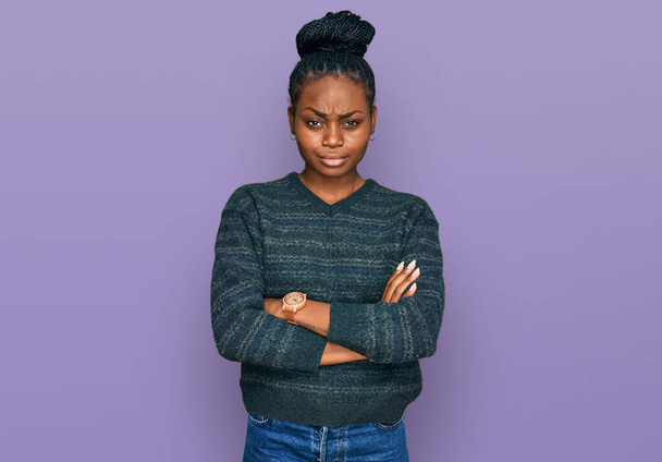Young african american woman wearing casual clothes skeptic and nervous, disapproving expression on face with crossed arms. negative person.  - Photo, Image