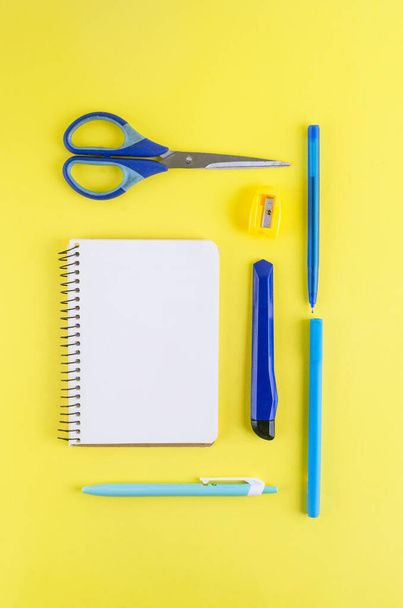 Back to school concept. Pencil case with school stationery on a yellow background. notebook paper, pencil, paper clip and sticky note with copy space,  - Фото, зображення
