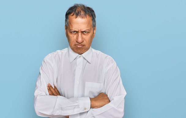 Middle age indian man wearing casual white shirt skeptic and nervous, disapproving expression on face with crossed arms. negative person.  - Photo, Image