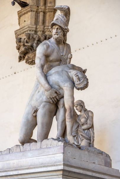 Artistic ancient statue representing the body of Menelaus being recovered on a pedestal in the Loggia dei Lanzi - Fotó, kép