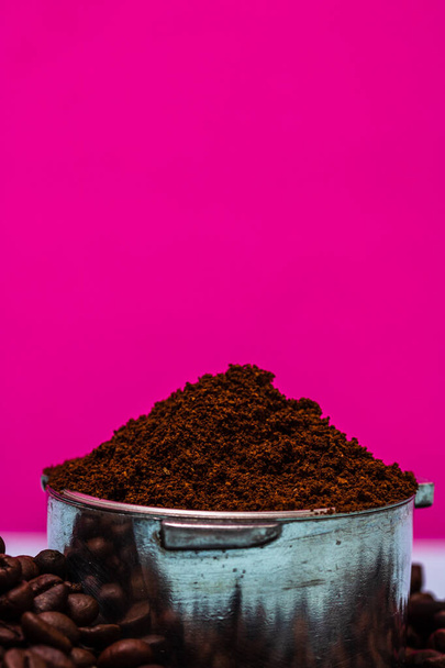 Close up of portafilter with ground coffee isolated on pink background - Photo, Image