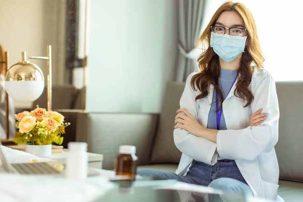 Portrait of  Young Asian woman in medical robe smiling and looking at camera during work .Healthcare concept. - 写真・画像