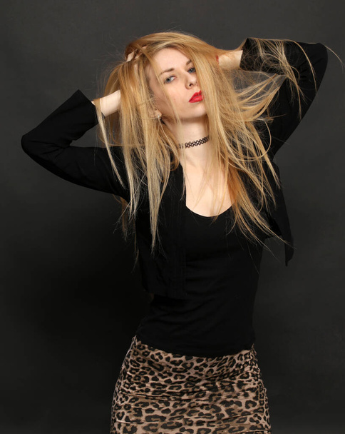 Beautiful blonde european girl with blue eyes posing in studio on isolated background. Style, trends, modeling, fashion concept. - Valokuva, kuva