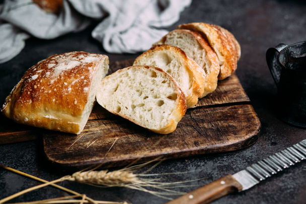 Homemade Ciabatta Bread. Sliced bread slices on a wooden board. Bread  - Zdjęcie, obraz