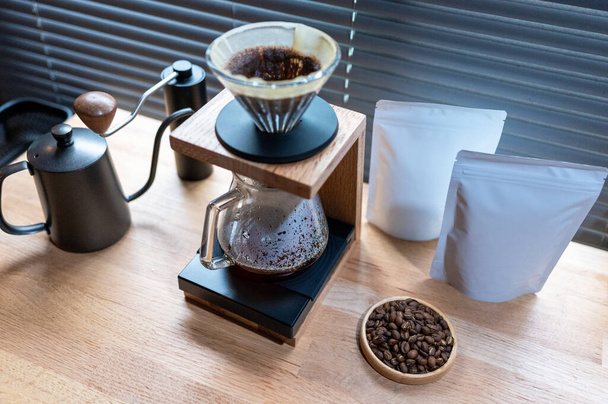 Hand drip coffee, Barista making drip coffee with mockup blank package coffee Alternative ways of brewing Coffee shop concept. - 写真・画像