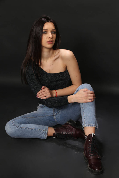 Beautiful, stylish brunette female model posing in studio on isolated background. Style, lifestyle, fashion concept. - Фото, изображение
