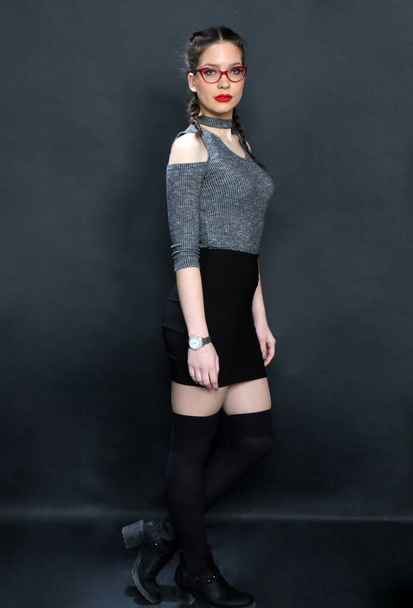 Attractive young caucasian girl posing in studio on isolated background. Style, trends, fashion concept. - Photo, Image