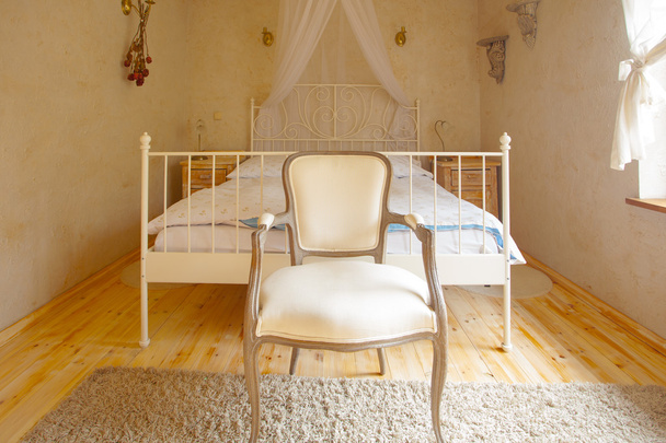 Interior of bedroom. Canopy bed and retro chair. - Foto, immagini
