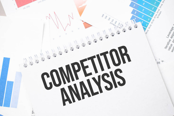 COMPETITOR ANALYSIS text on paper on the chart background with pen - Photo, image