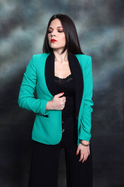 Attractive girl with black hair is posing in studio. Style, trends, fashion concept. - Fotó, kép