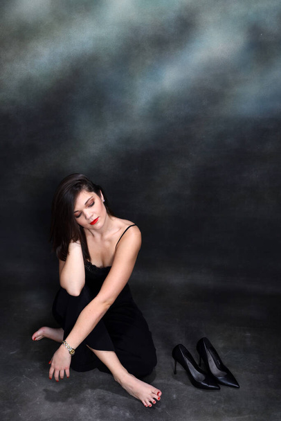 Attractive girl with black hair is posing in studio. Style, trends, fashion concept. - Foto, Imagem
