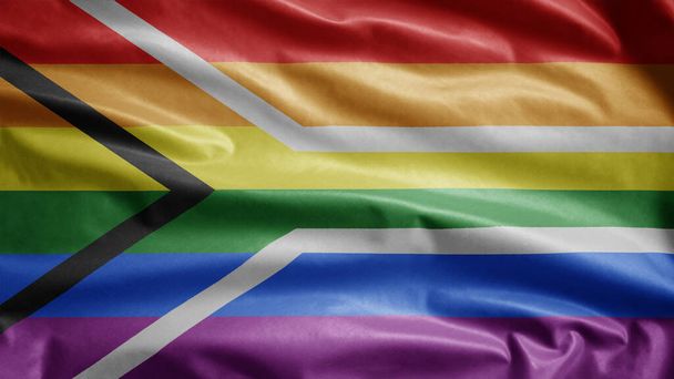 La bandiera dell'orgoglio gay sudafricano sventola nel vento. Primo piano dello striscione della comunità LGBT sudafricana che soffia seta liscia. Tessuto tessuto trama guardiamarina sfondo. Usalo per orgoglio gay giorno ed eventi concetto - Foto, immagini
