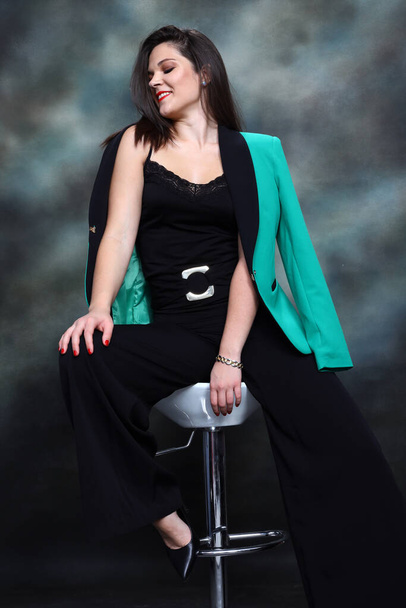 Attractive girl with black hair is posing in studio. Style, trends, fashion concept. - Zdjęcie, obraz