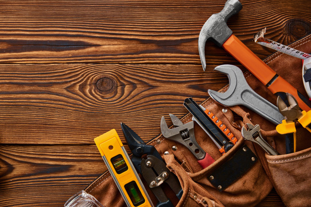 Professional workshop instrument, macro view, wooden background, nobody. Carpenter tools, builder equipment, screwdriver and wrench, piles and metal scissors, hammer and level - Photo, Image