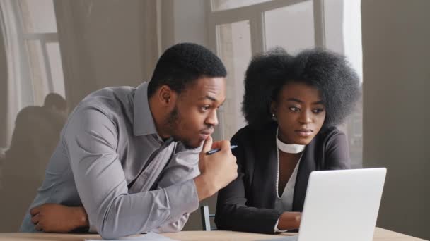 African American satisfied woman and man working together in office. Look at laptop screen, received good news letter, employee report, excellent financial performance. Surprised successful results - Footage, Video