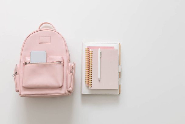 Student female backpack full of schooler supplies isolated with copy space. Back to school concept - Фото, изображение