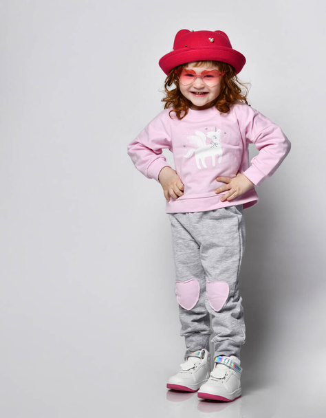 Cute little smiling shy preschool toddler girl child studio shot - Foto, Bild