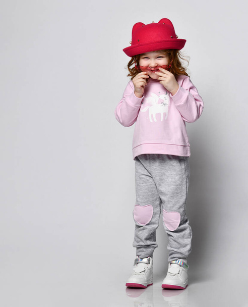 Cute little smiling shy preschool toddler girl child studio shot - 写真・画像