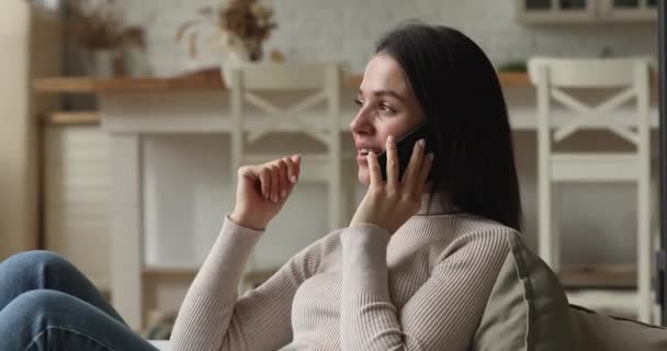 Woman sit on sofa lead pleasant conversation remotely by phonecall - Séquence, vidéo